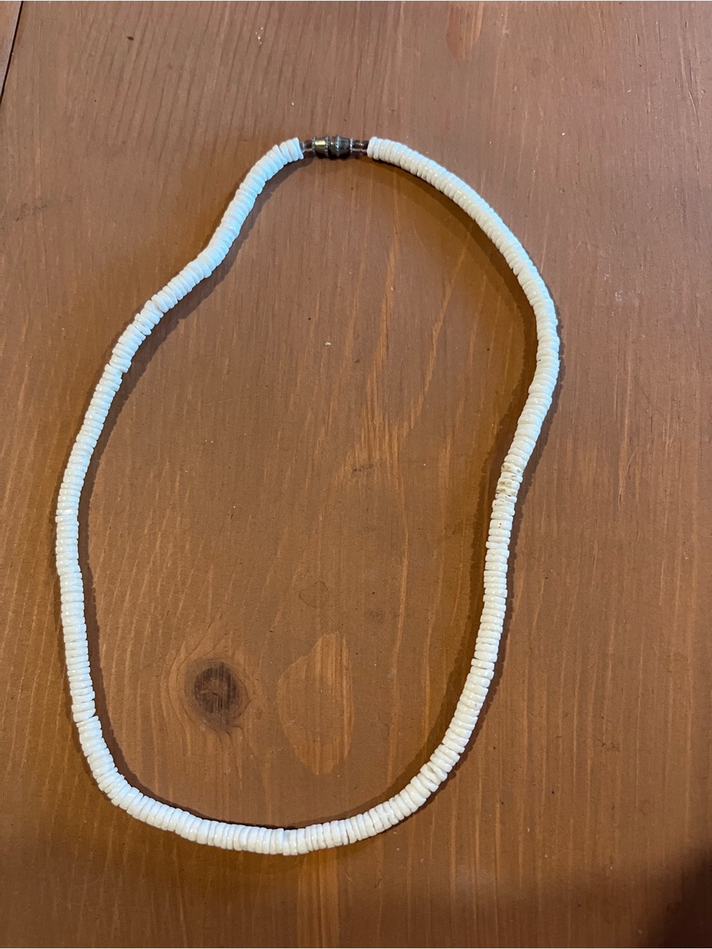 Natural shell necklace with twist on clasp, like a puka shell but smaller shells